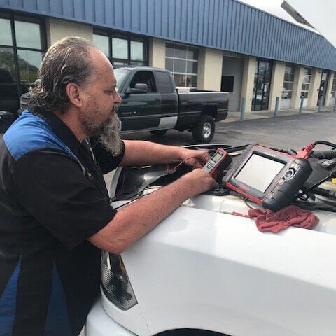 man diagnosing car issues