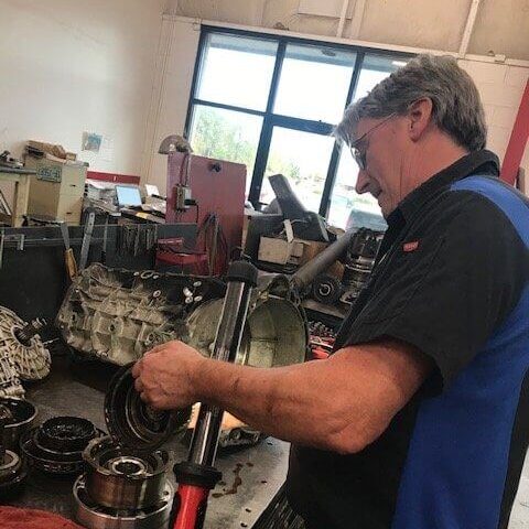 man servicing transmission